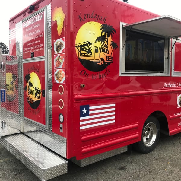 Red Kendejah Restaurant food truck with Liberian flag and menu details for West African cuisine.