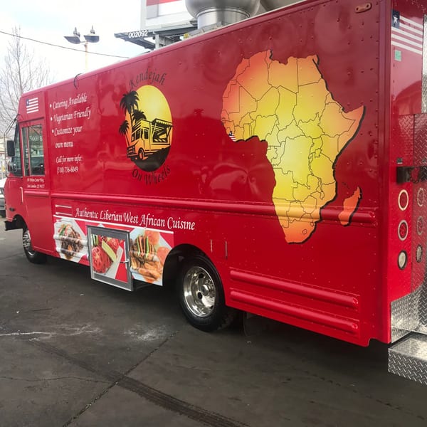 Red Kendejah food truck with an African map and food images on its side.