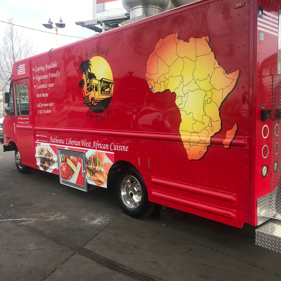 Red Kendejah food truck with an African map and food images on its side.
