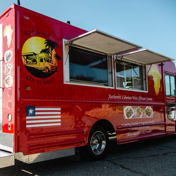 Red Kendejah food truck with "Authentic Liberian West African Cuisine" text and a Liberian flag.